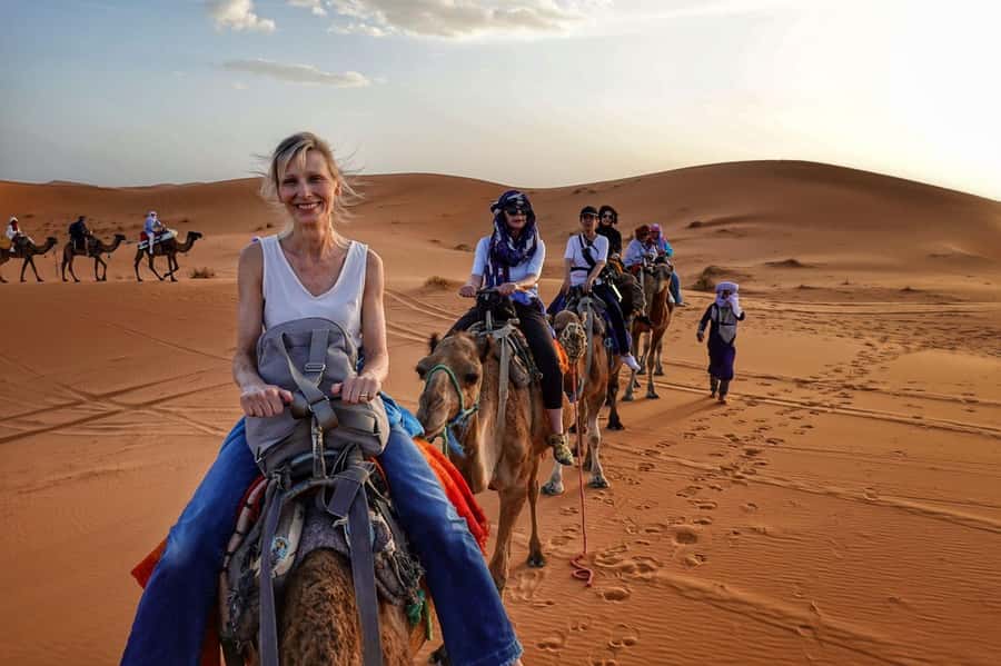 From Merzouga: Overnight Camel Trek over Erg Chebbi Dunes - Guides, camel care, and tips that help the people involved